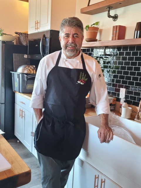 Portrait of lead chef at Knife, Herb, and Fire catering